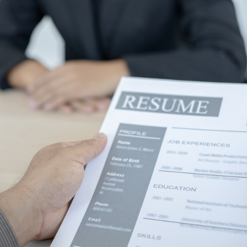 person holding a resume at a job interview