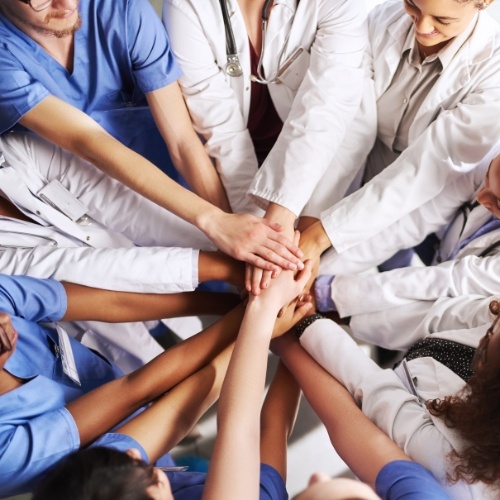 doctors with hands together in a circle