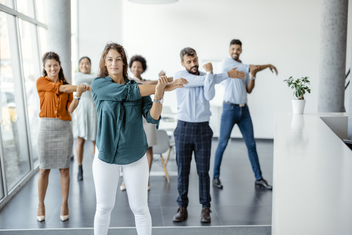 people stretching in an office