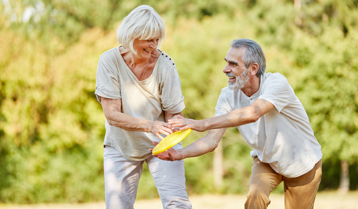 Senior citizens playing frisbee as part of a wellness event