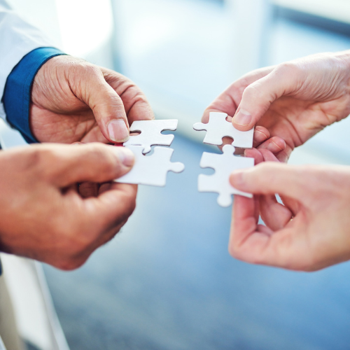 medical professionals holding puzzle pieces